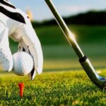 Teeing up a golf ball on a red tee